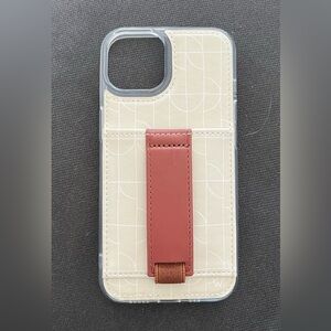 iPhone 13 case by Walli. Cream with white design and red/brown fingers strap.